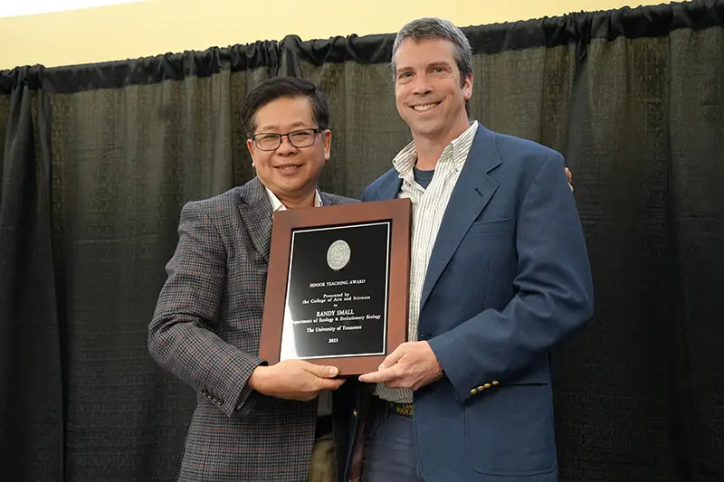 Randy Small is presented with an award by Liem Tran at the Faculty Awards Banquet