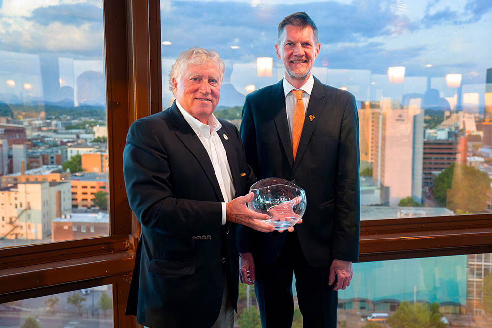 Winner of the Volunteer of the Year Award, Mike Dennis, poses with Dean of the College of Arts and Sciences, Robert Hinde